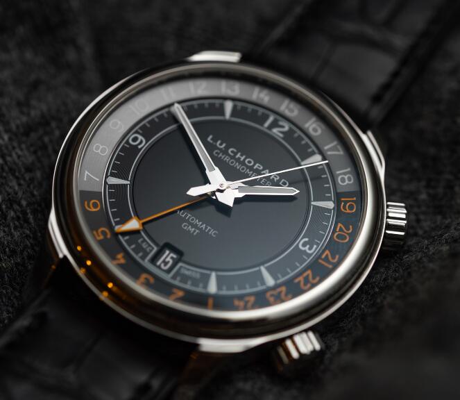 The orange hour markers are striking on the black dial.