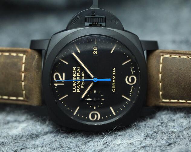 The blue second hand is contrasted to the black dial.