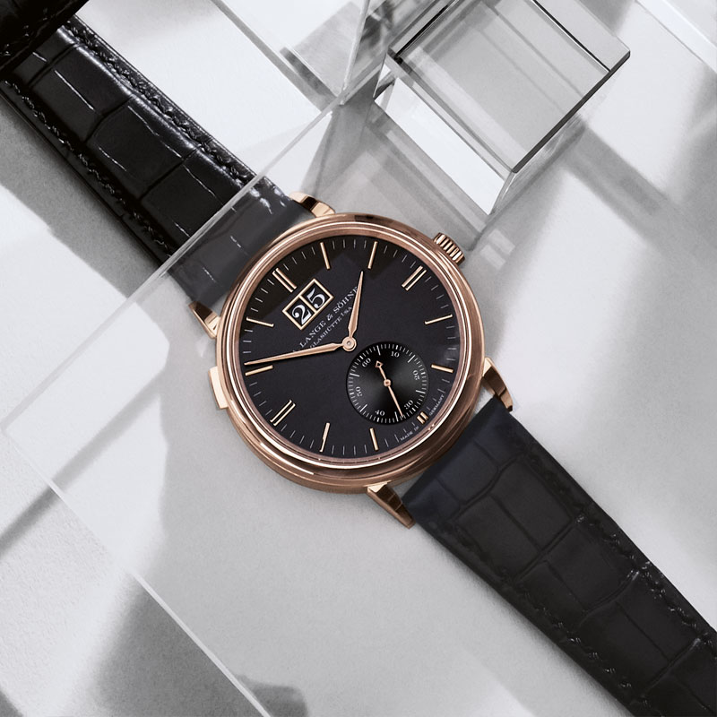 The 18k rose gold copy watch has black dial.